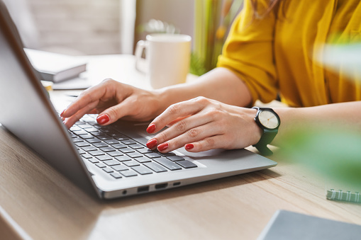 Cropped image of business woman hand working laptop computer in home office Compare Other Scotiabank Products