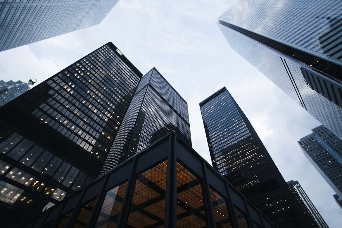 An upward view of glass skyscrapers in the city