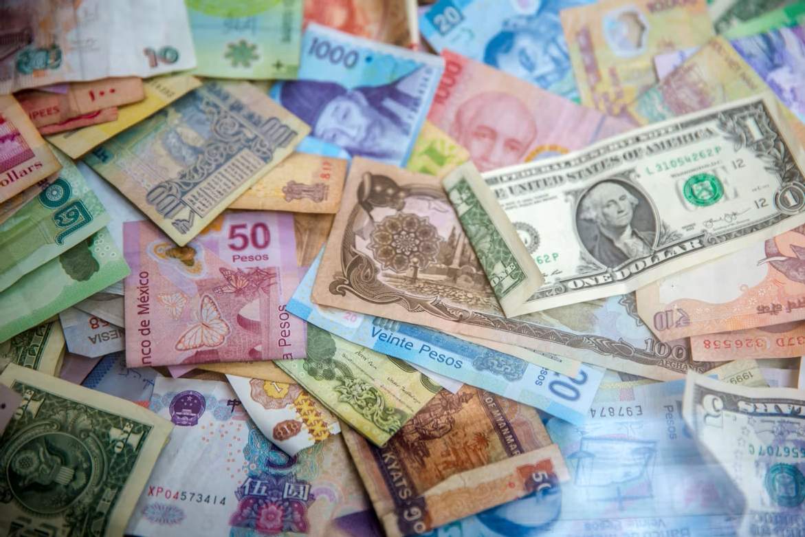 Multiple different currencies spread out, including dollars and pesos